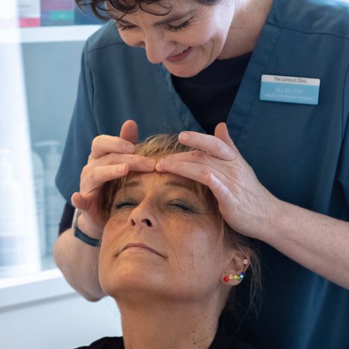 Holistic health and beauty therapist treats a client at The Lomond Clinic, Helensburgh