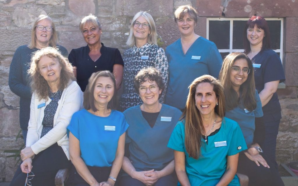 Informal group photo of some of the team members at The Lomond Clinic, Helensburgh, highlighting published authors Diane Carole (Wilkie) and Carolyn Aitken.