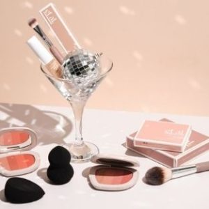 Et al make up products with a cocktail glass and Christmas decoration