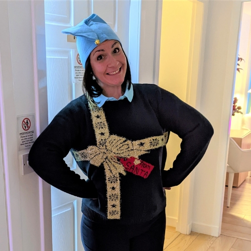 Rachael dressed as an elf in a Christmas jumper for The Lomond Clinic Elf Service christmas present service