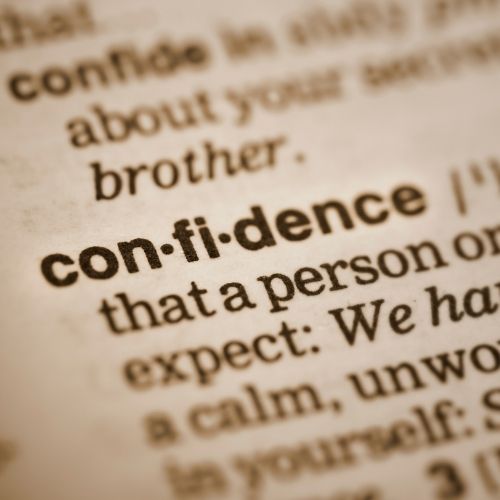 Close up of text from a dictionary showing definition of confidence