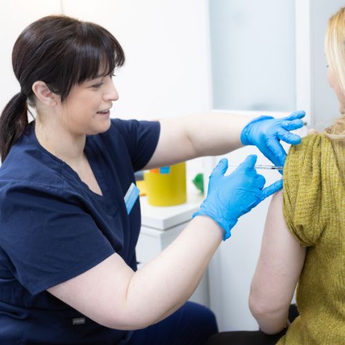 Travel nurse Anna Blackshaw giving a vaccination at The Lomond Clinic, Helensburgh