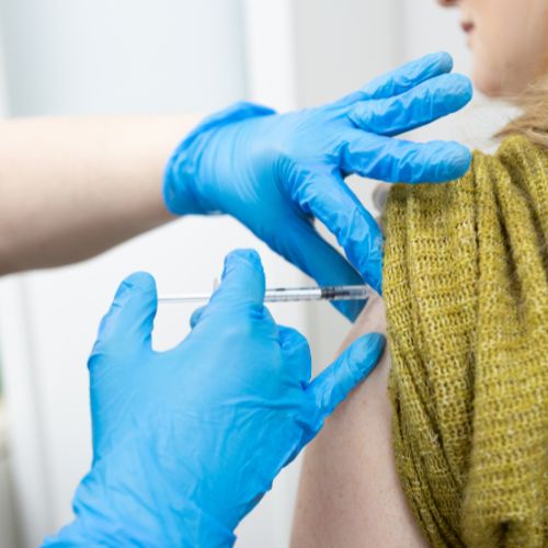 Close up of travel nurse Anna Blackshaw administering a vaccination at The Lomond Clinic, Helensburgh