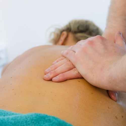 Close up of a massage therapist's hands treating a female massage client at The Lomond Clinic, Helensburgh